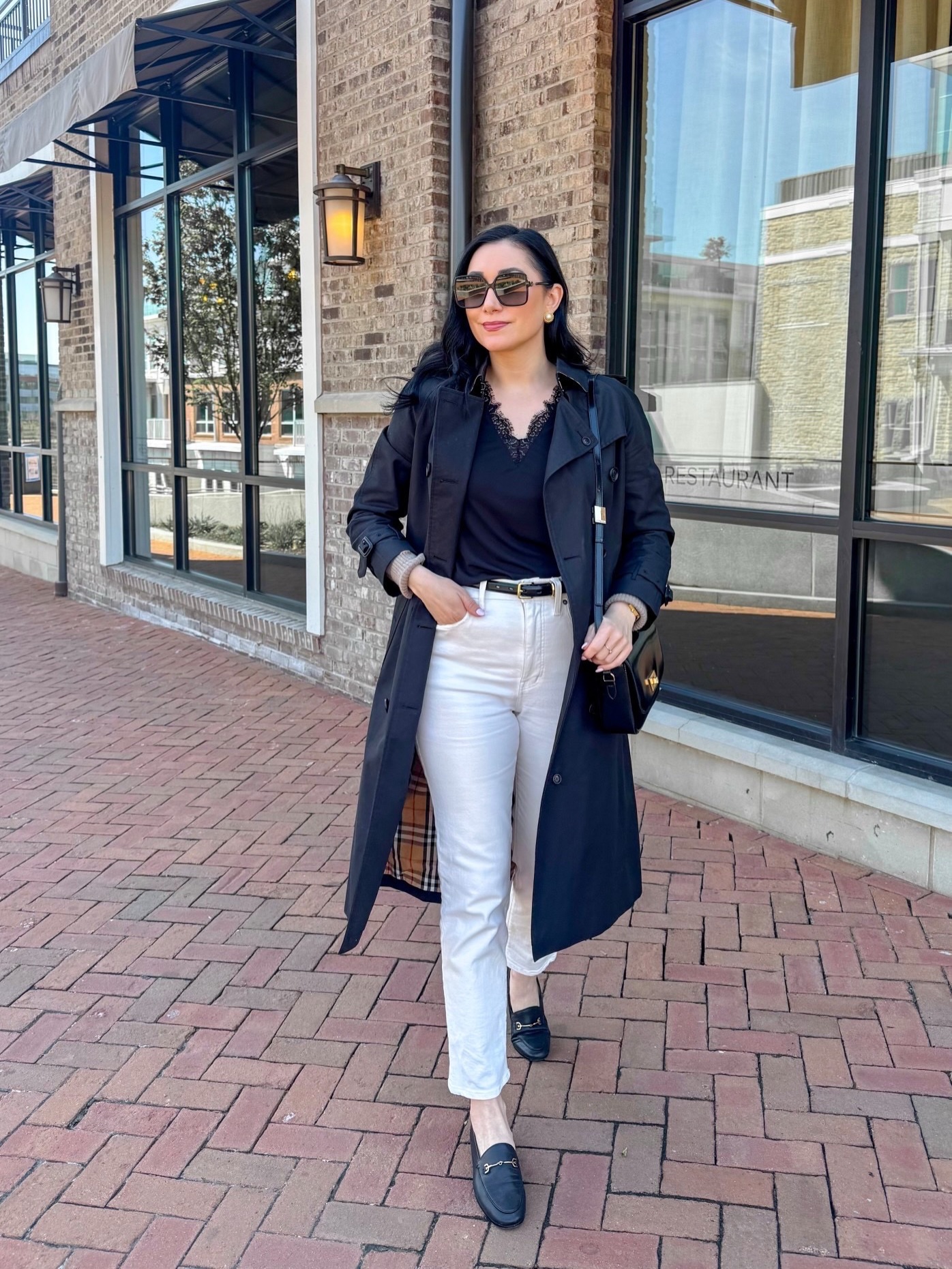 A Black Trench, White Jeans, and Loafers Outfit That Shows How Powerful Simple Contrast Can Be